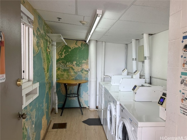 shared laundry area with light wood-type flooring and washing machine and clothes dryer