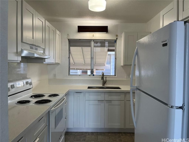 kitchen featuring white cabinetry, light stone countertops, sink, and white appliances