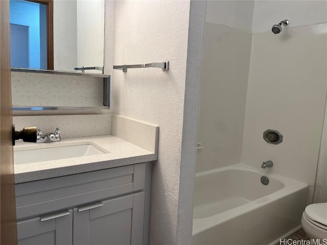 full bathroom featuring  shower combination, toilet, and vanity