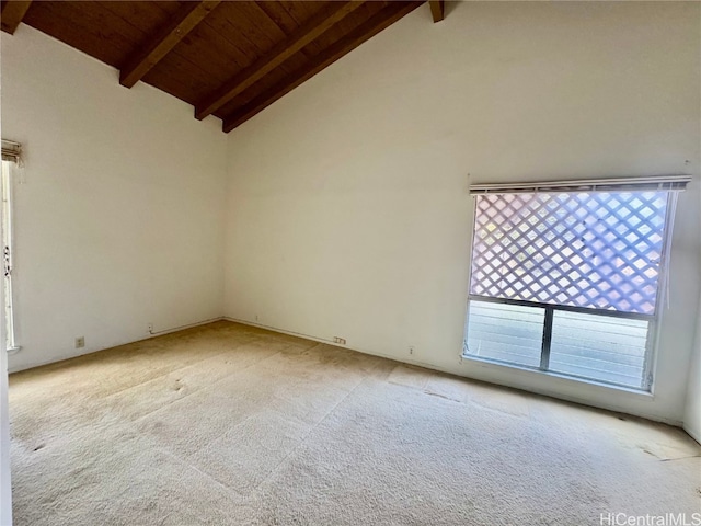 unfurnished room with beamed ceiling, high vaulted ceiling, light carpet, and wood ceiling