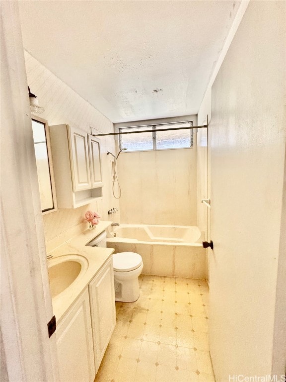 full bathroom with vanity, tiled shower / bath combo, a textured ceiling, and toilet