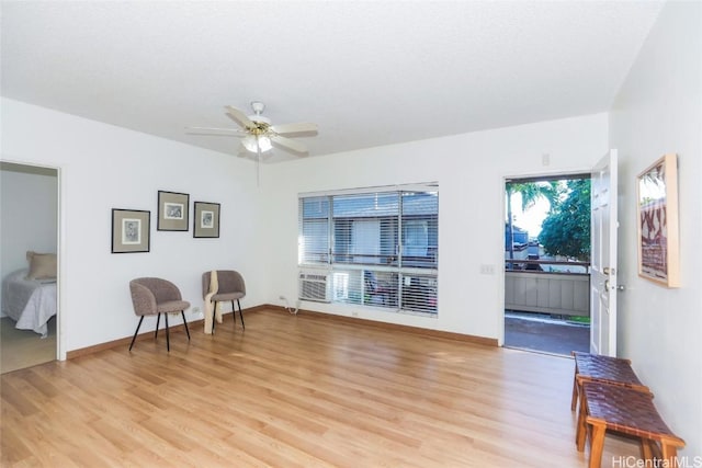 living area featuring ceiling fan and light hardwood / wood-style floors