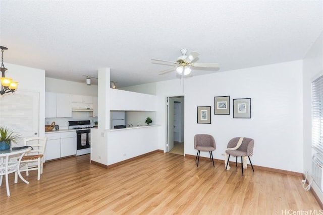 kitchen featuring ceiling fan with notable chandelier, white range with gas cooktop, and light hardwood / wood-style floors