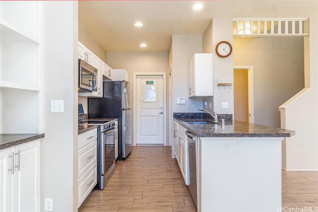 kitchen featuring stainless steel appliances, sink, and white cabinets