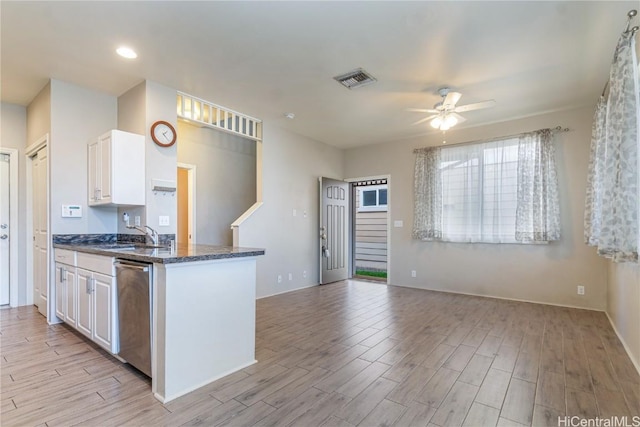 kitchen featuring dishwasher, light wood-type flooring, and white cabinets