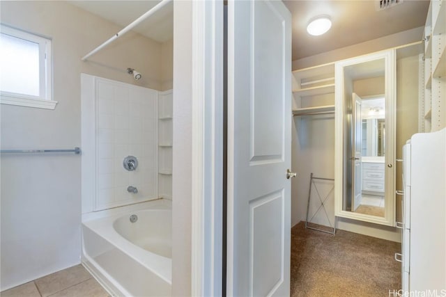 bathroom featuring washtub / shower combination and tile patterned flooring