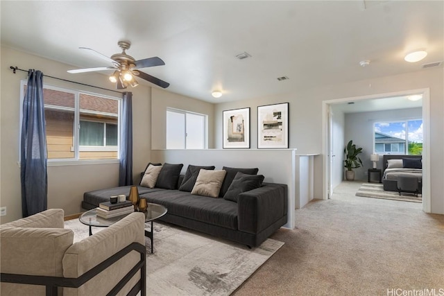 living room with light carpet and ceiling fan