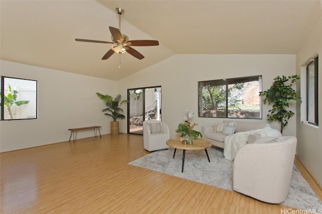 living room featuring ceiling fan, lofted ceiling, and wood-type flooring