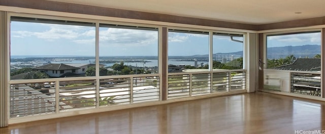 unfurnished sunroom featuring a water view