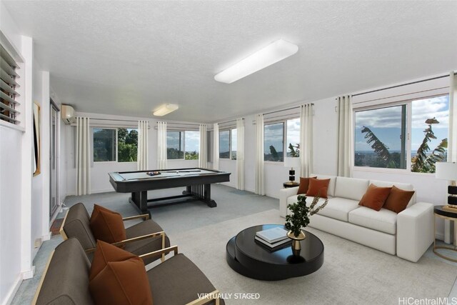 carpeted living room with a wall mounted air conditioner, a wealth of natural light, and a textured ceiling