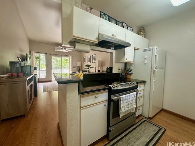 kitchen featuring white cabinets, stainless steel range with electric stovetop, white fridge, light hardwood / wood-style floors, and kitchen peninsula