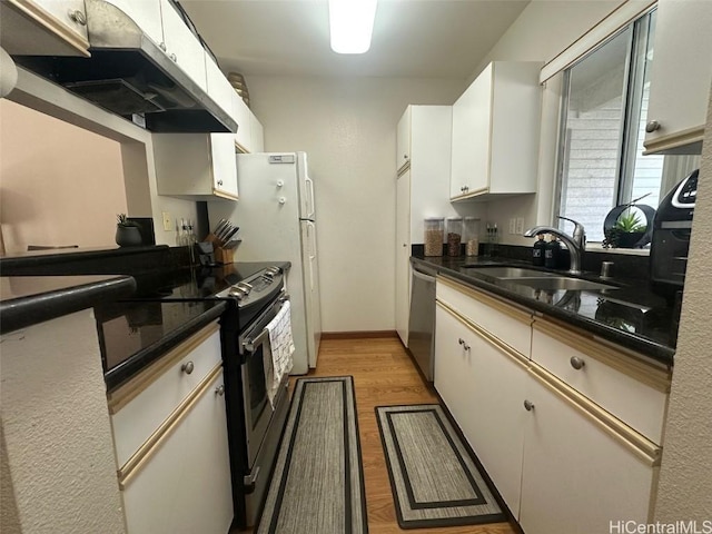 kitchen with white cabinetry, appliances with stainless steel finishes, light hardwood / wood-style floors, and sink