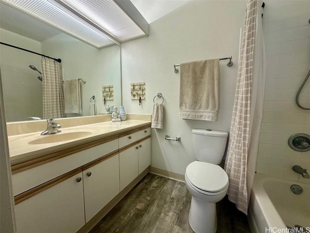 full bathroom with vanity, wood-type flooring, toilet, and shower / bath combo