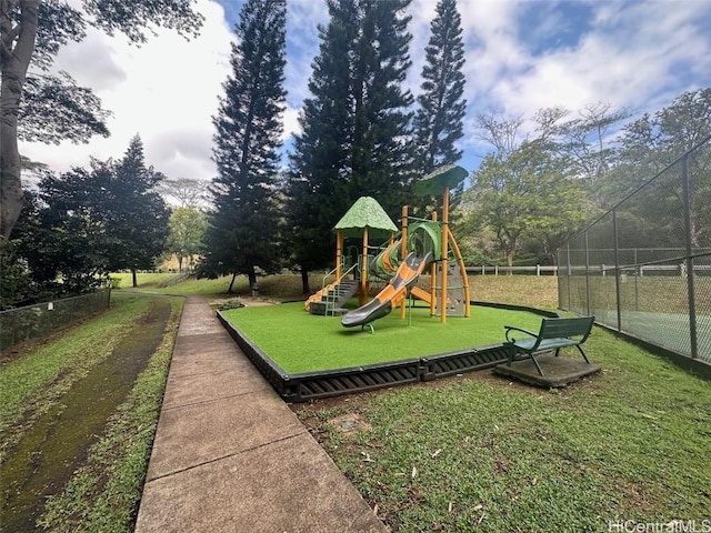 view of jungle gym featuring a lawn