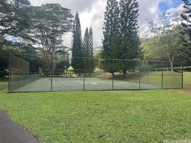 view of sport court with a playground and a lawn