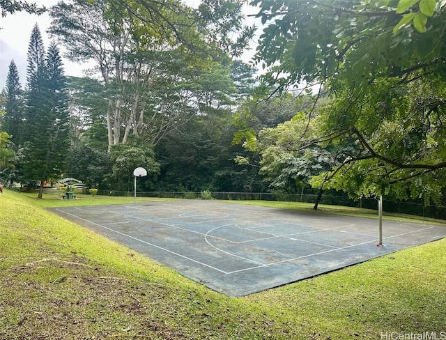 view of basketball court with a lawn