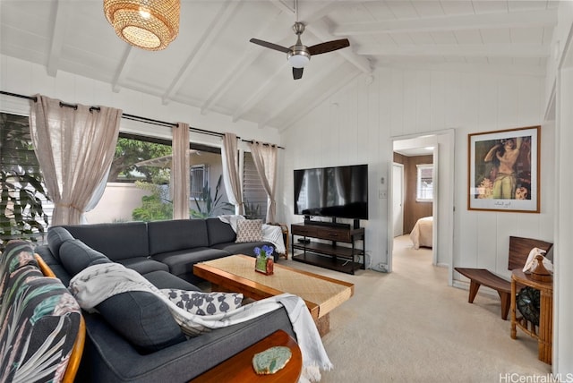 carpeted living room featuring vaulted ceiling with beams and ceiling fan