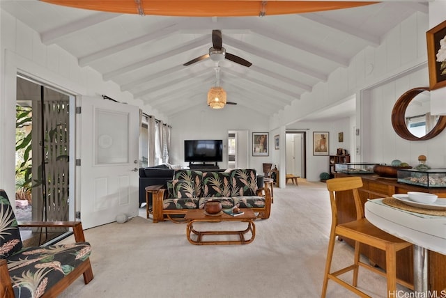 living area with vaulted ceiling with beams, carpet, and ceiling fan