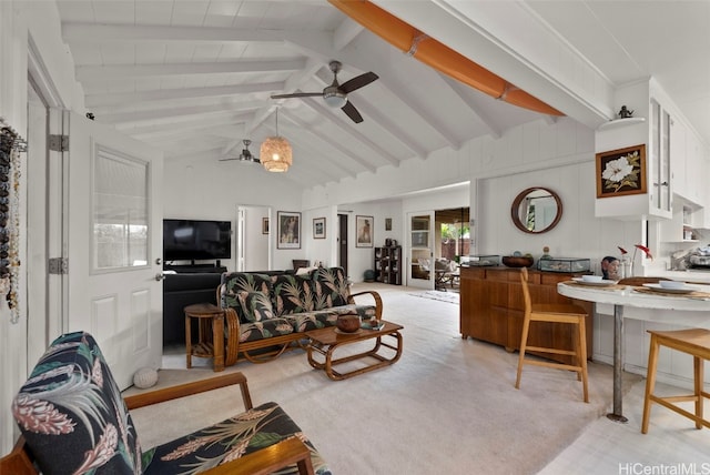 living room featuring a ceiling fan and lofted ceiling with beams