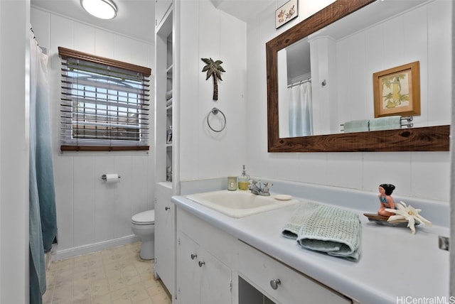 bathroom featuring curtained shower, vanity, toilet, and tile patterned floors