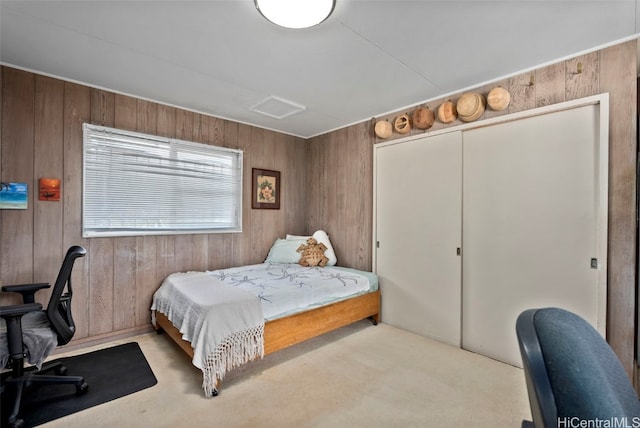 bedroom featuring a closet, carpet, and wooden walls