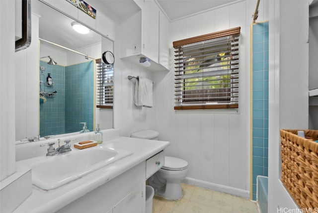 bathroom featuring a shower, vanity, toilet, and tile patterned floors