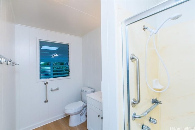 bathroom with vanity, wood-type flooring, a shower, and toilet