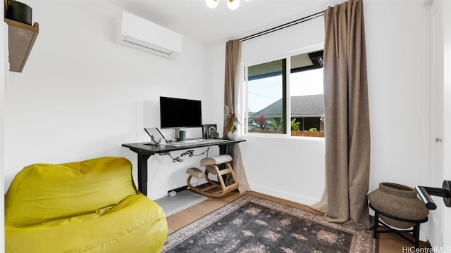 office with a wall mounted air conditioner and wood-type flooring