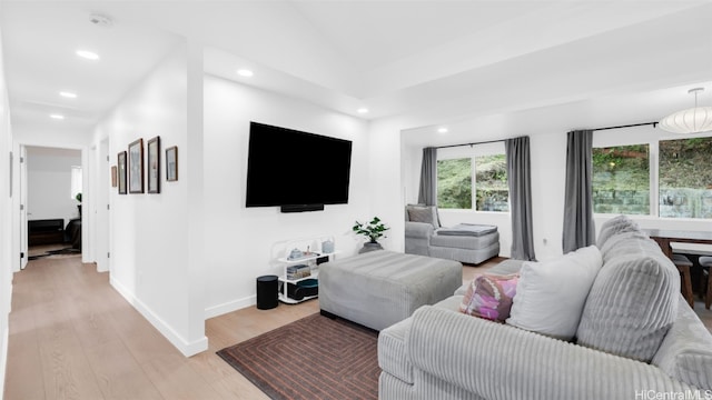 living room featuring vaulted ceiling and light wood-type flooring