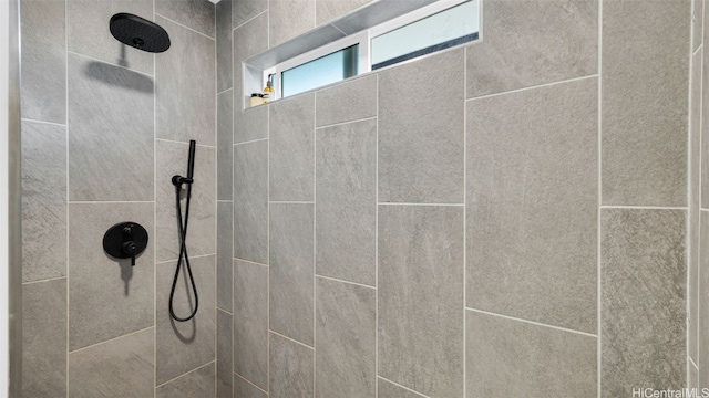 interior details with a tile shower