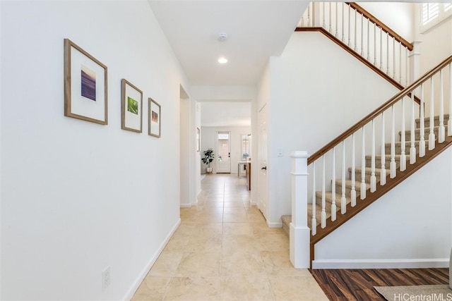 hall with light tile patterned flooring and a wealth of natural light