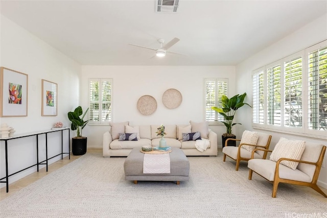 tiled living room featuring ceiling fan