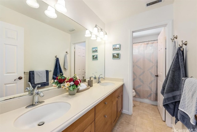 bathroom with vanity, a shower with curtain, tile patterned floors, and toilet