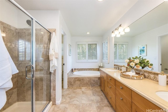 bathroom with independent shower and bath and vanity