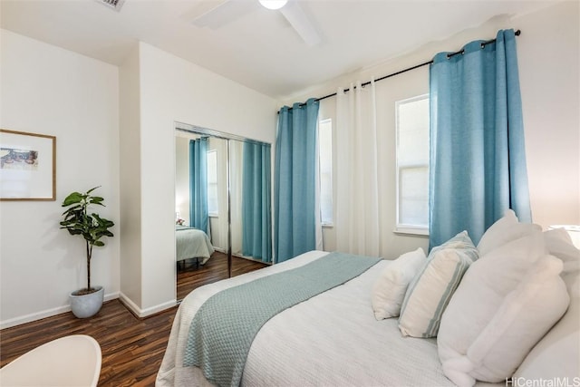 bedroom with ceiling fan, dark hardwood / wood-style floors, and a closet