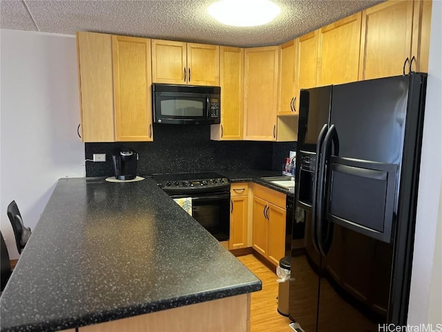 kitchen with black appliances, backsplash, light hardwood / wood-style floors, kitchen peninsula, and light brown cabinets