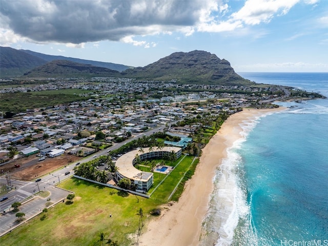 birds eye view of property featuring a water and mountain view and a beach view