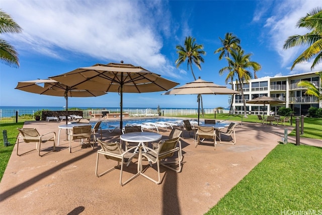 view of patio / terrace with a community pool and a water view