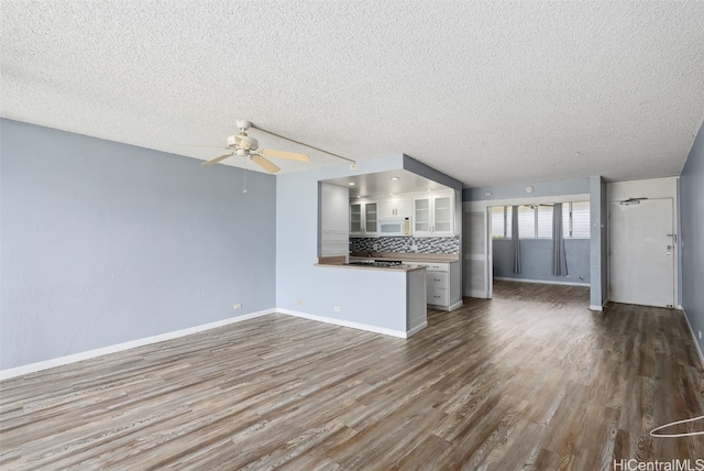 unfurnished living room with hardwood / wood-style flooring, a textured ceiling, and ceiling fan