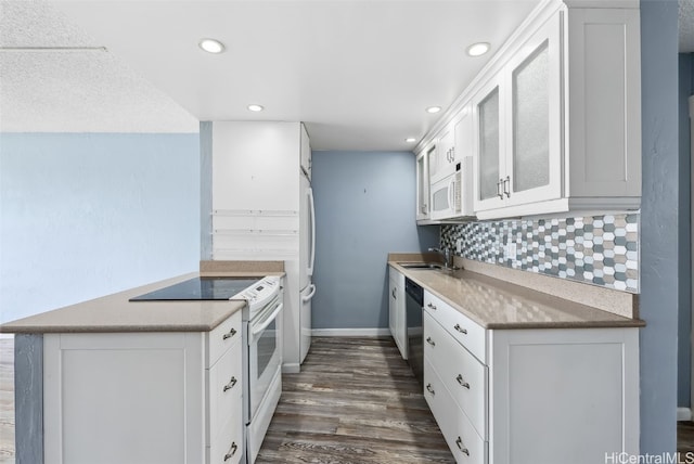 kitchen featuring sink, white appliances, dark wood-type flooring, white cabinetry, and backsplash