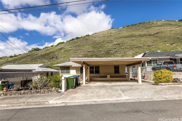 view of front of property with a carport and a mountain view