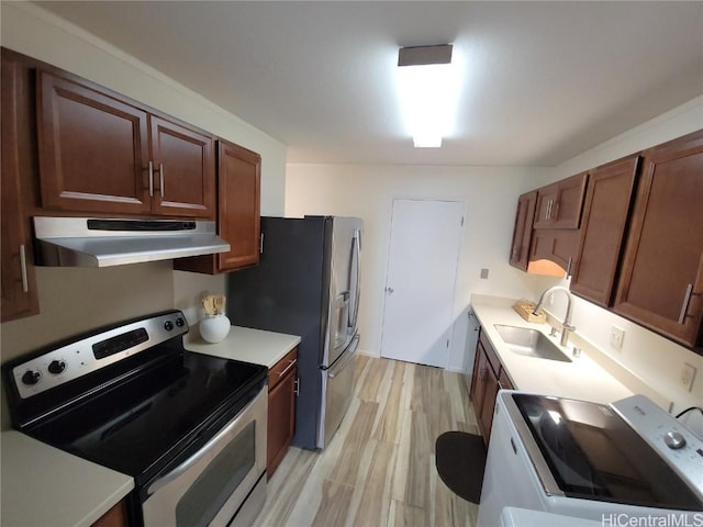 kitchen with stainless steel appliances, sink, and light hardwood / wood-style flooring