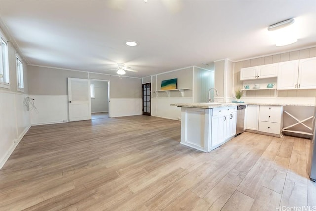 kitchen featuring light wood finished floors, white cabinets, and light countertops