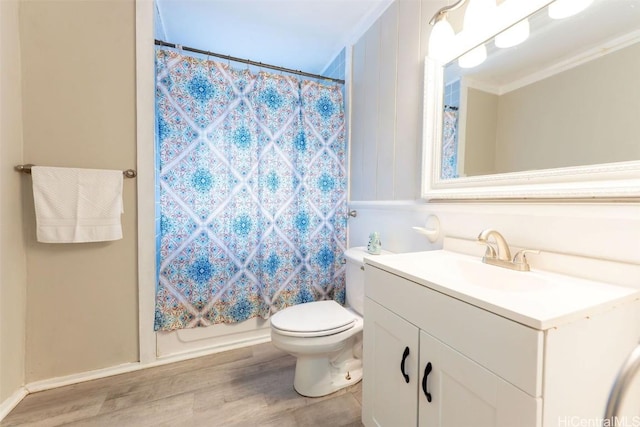 bathroom with curtained shower, crown molding, toilet, wood finished floors, and vanity