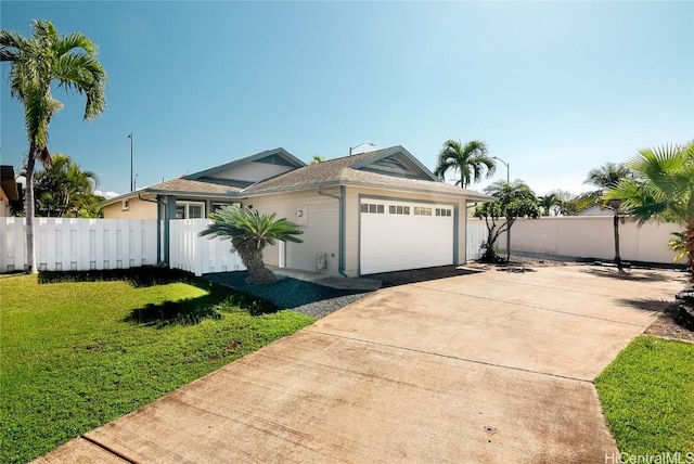 view of front of property featuring a garage and a front lawn