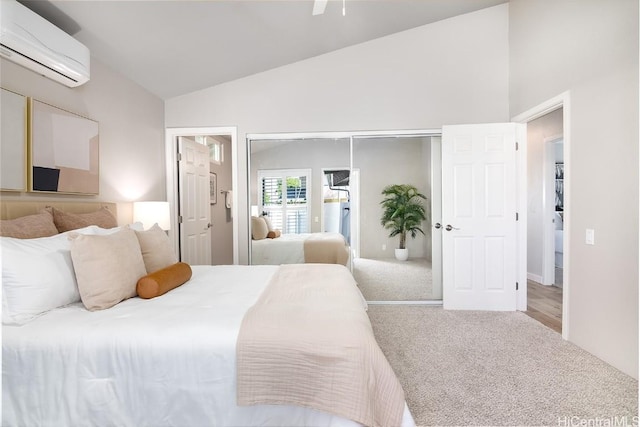 carpeted bedroom with high vaulted ceiling, a closet, and a wall mounted AC