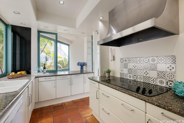 kitchen featuring wall chimney exhaust hood, sink, white cabinetry, black electric cooktop, and white dishwasher