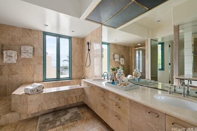 bathroom featuring vanity, shower with separate bathtub, and tile walls