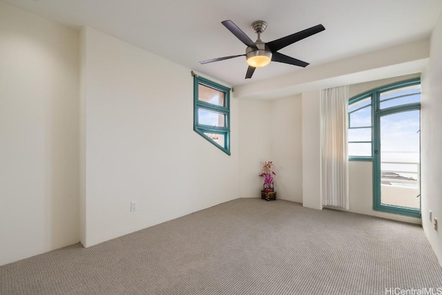 carpeted empty room featuring ceiling fan