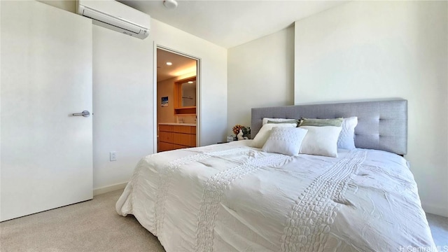 carpeted bedroom featuring an AC wall unit and ensuite bathroom